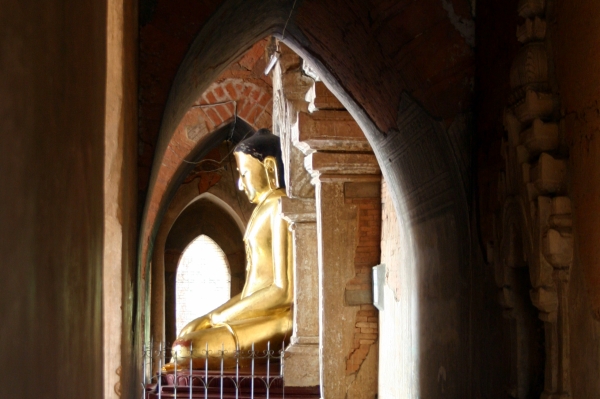 One of the Buddha images in the temple, lit from the sun streaming through an entrance