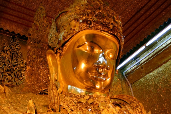 The gilt face of the Maha Muni Buddha image
