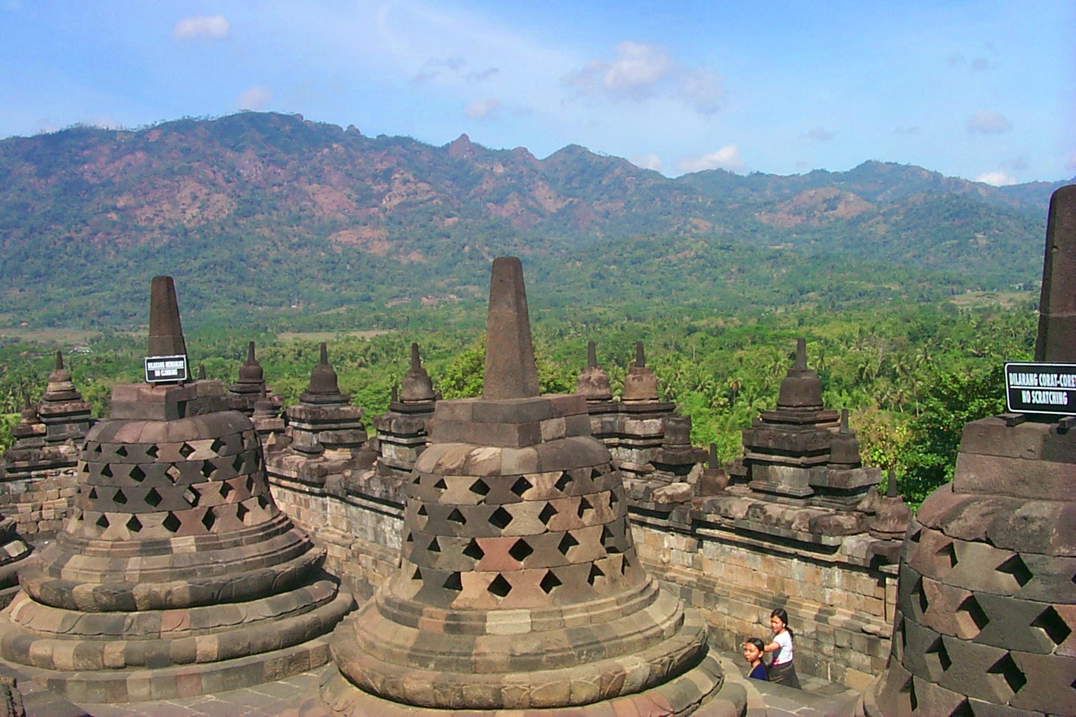 View of the latticework stupas against the distant mountains.