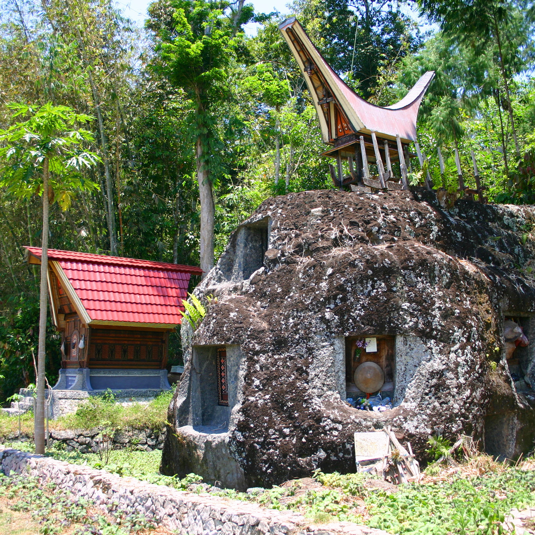 A single large boulder with several tombs carved into it