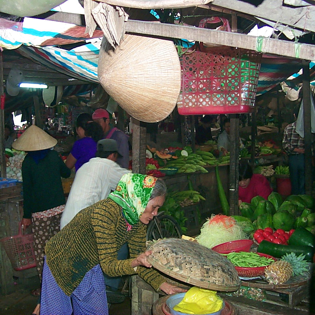 An old woman checks the merchandise